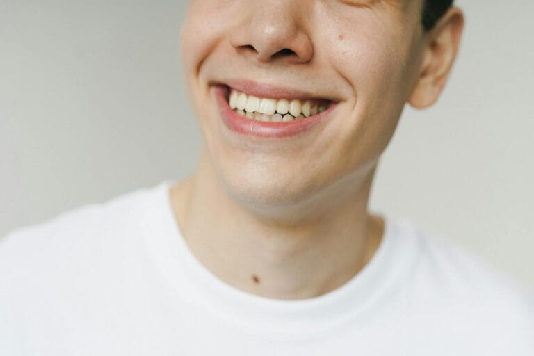 - Labasa A close-up shot of a young man smiling, highlighting his teeth and expression.